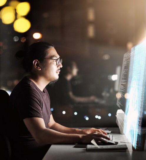 developer looking at code on monitor