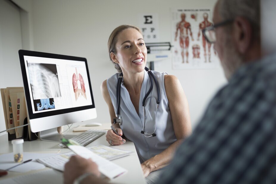 female doctor reviews imaging data on a computer screen with her patient