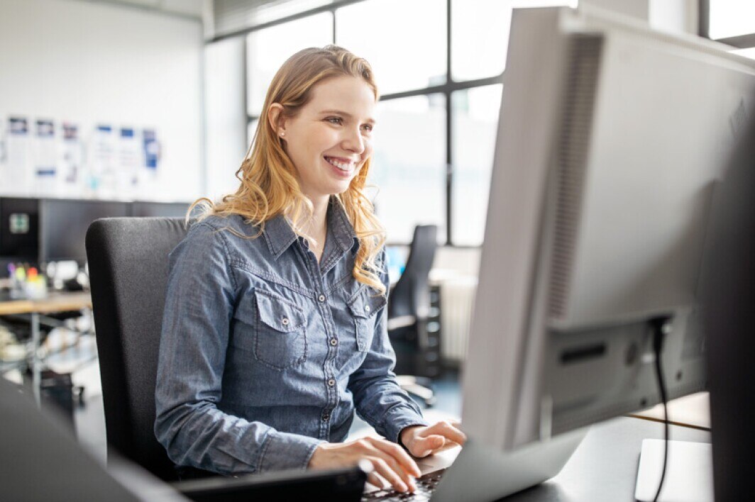 programmer working on a computer at her desk