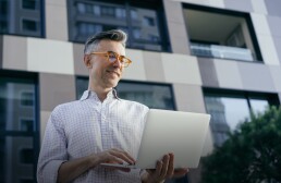 smiling mature man using laptop computer