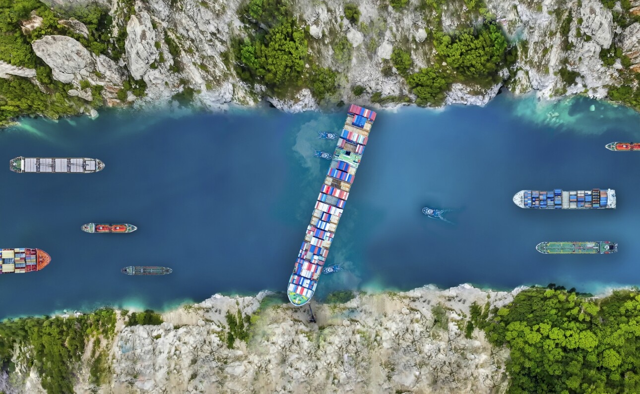 Aerial view/A large cargo ship swept through the waterways in the Suez Canal, making it impossible for other ships to go.