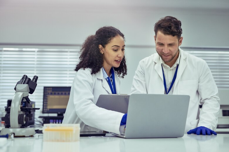 Scientists working in lap on computer