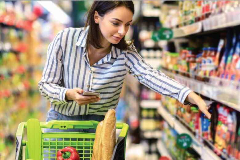 woman shopping in the aisle of a grocery store