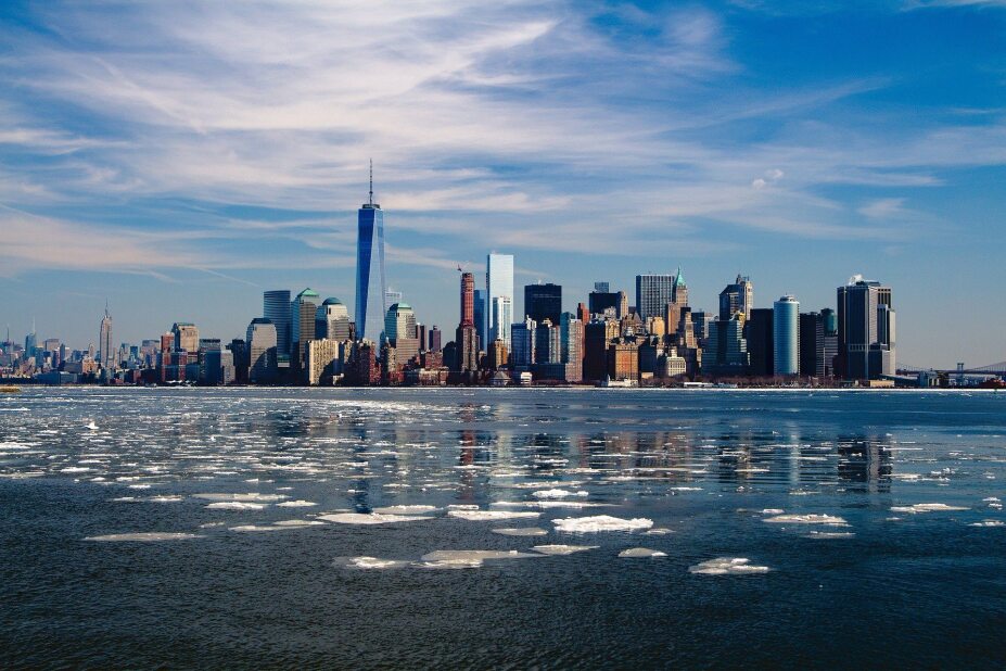 view of New York City skyline from across an icy river