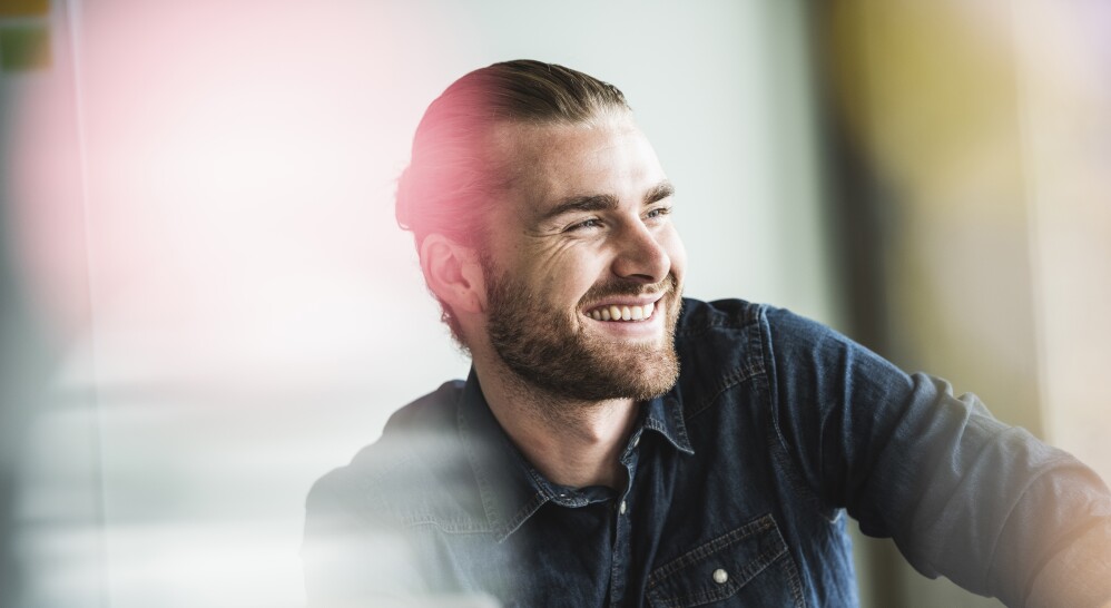 Portrait of smiling young businessman in office