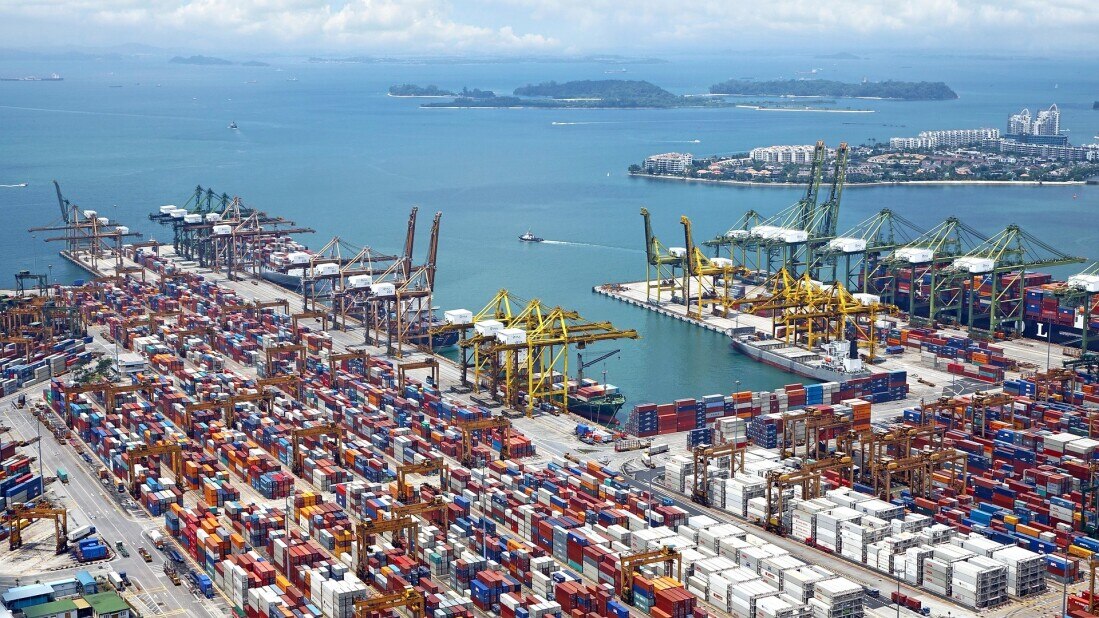 busy dock in a port where large shipping containers are ready to be loaded onto ships