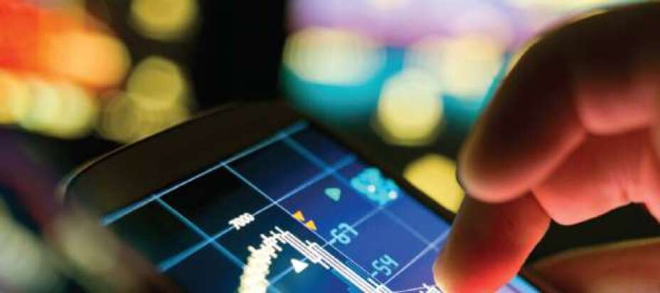 close up of fingers tapping a touch screen displaying data