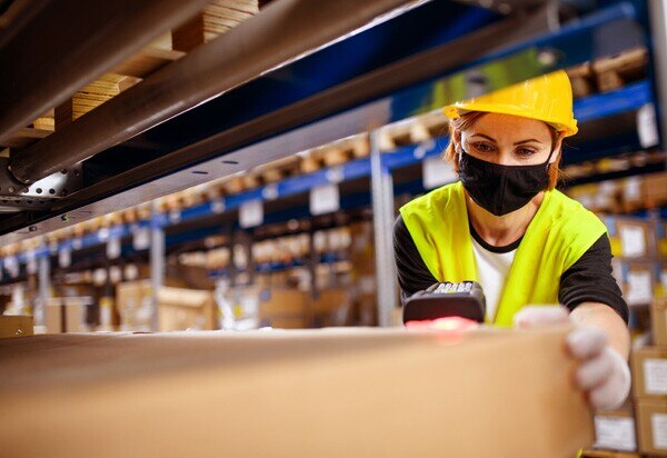 warehouse worker scanning a package for shipping
