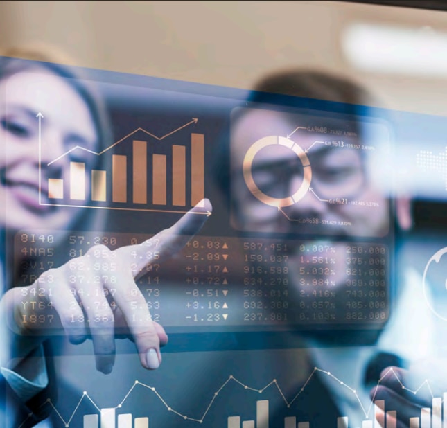 Two people looking at demand sensing and forecasting data
