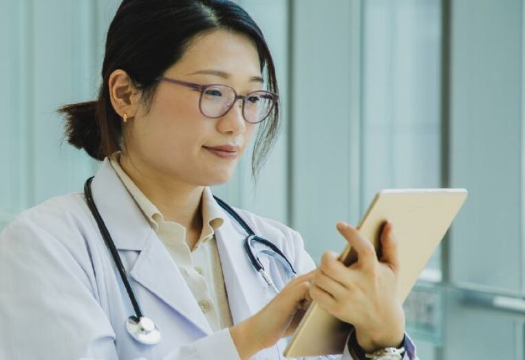 female doctor looking at ipad