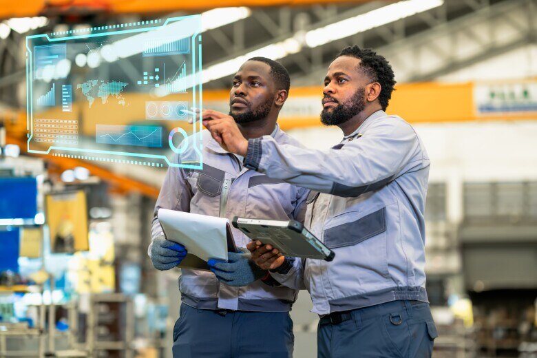Factory worker with laptops