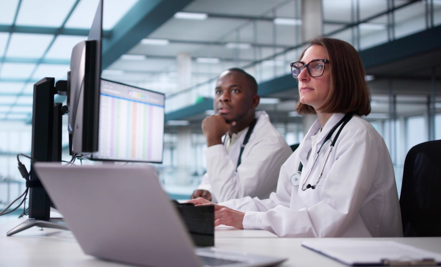 Doctor And Team In Hospital Setting looking at monitors