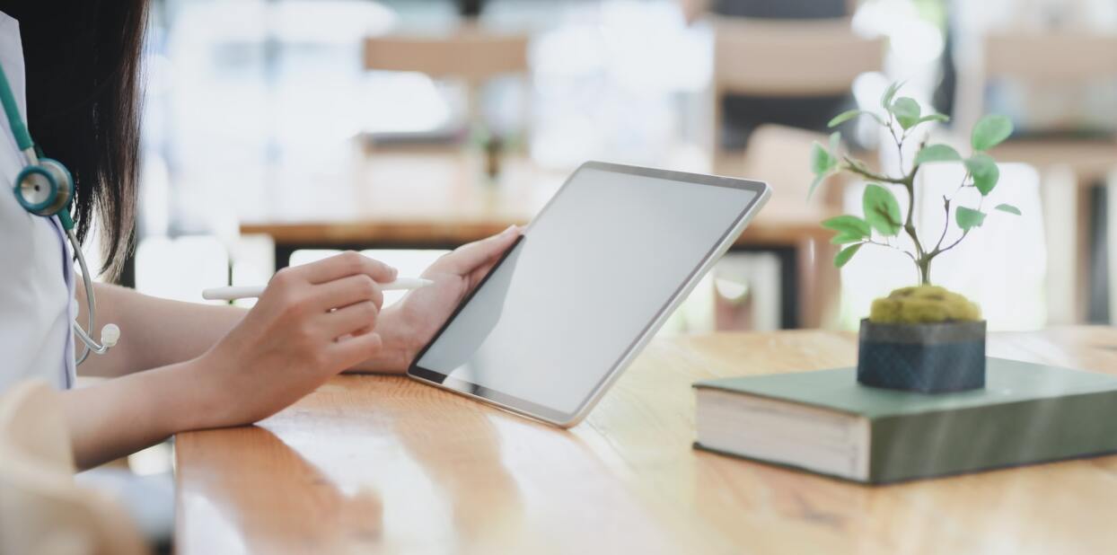 doctor accessing a patient's electronic data from a tablet