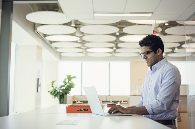 Chief Information Officer working from a high top desk