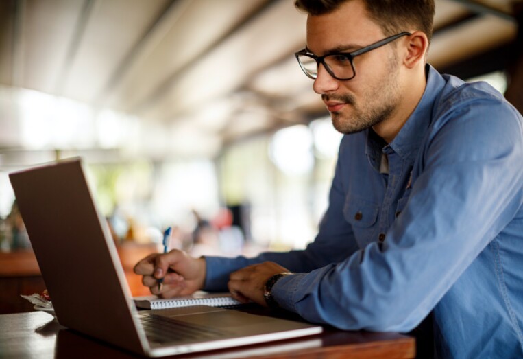 Young man working at a cafe