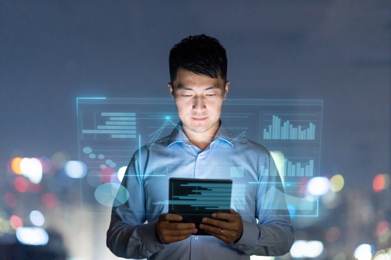 young asian businessman works with tablet against smart vr screen