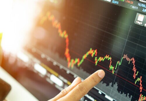 financial services professional analyzing a graph of financial data