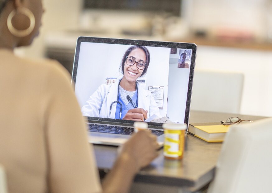 doctor and patient having a virtual visit on a laptop