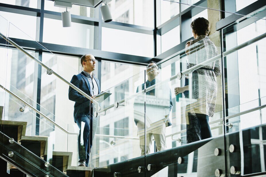 Business colleagues in discussion on office stairs