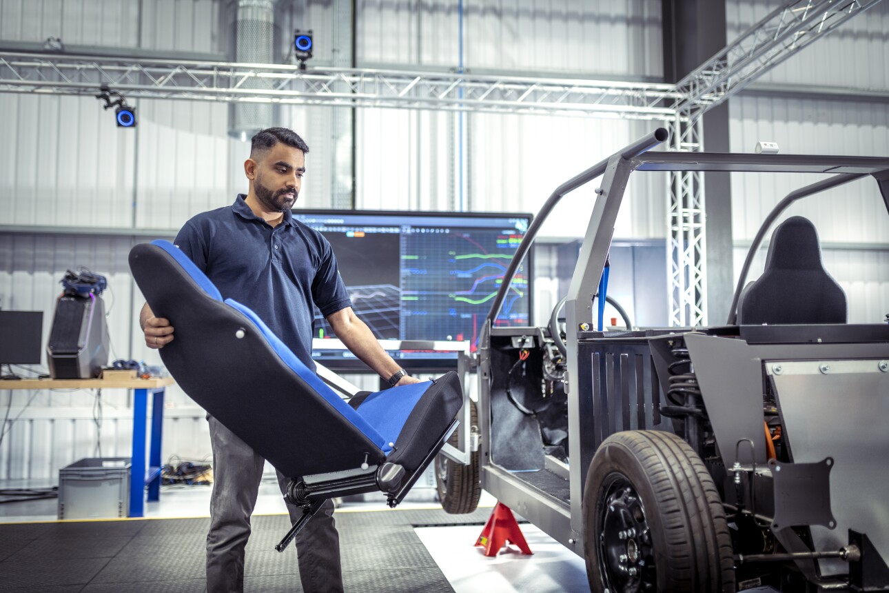 Worker carrying car seat