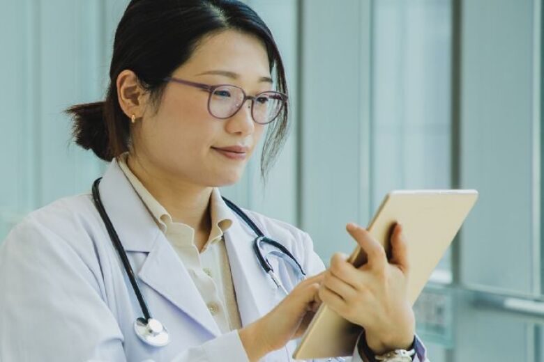 female doctor looking at ipad