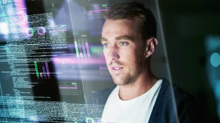 reflection of an app developer in his computer screen