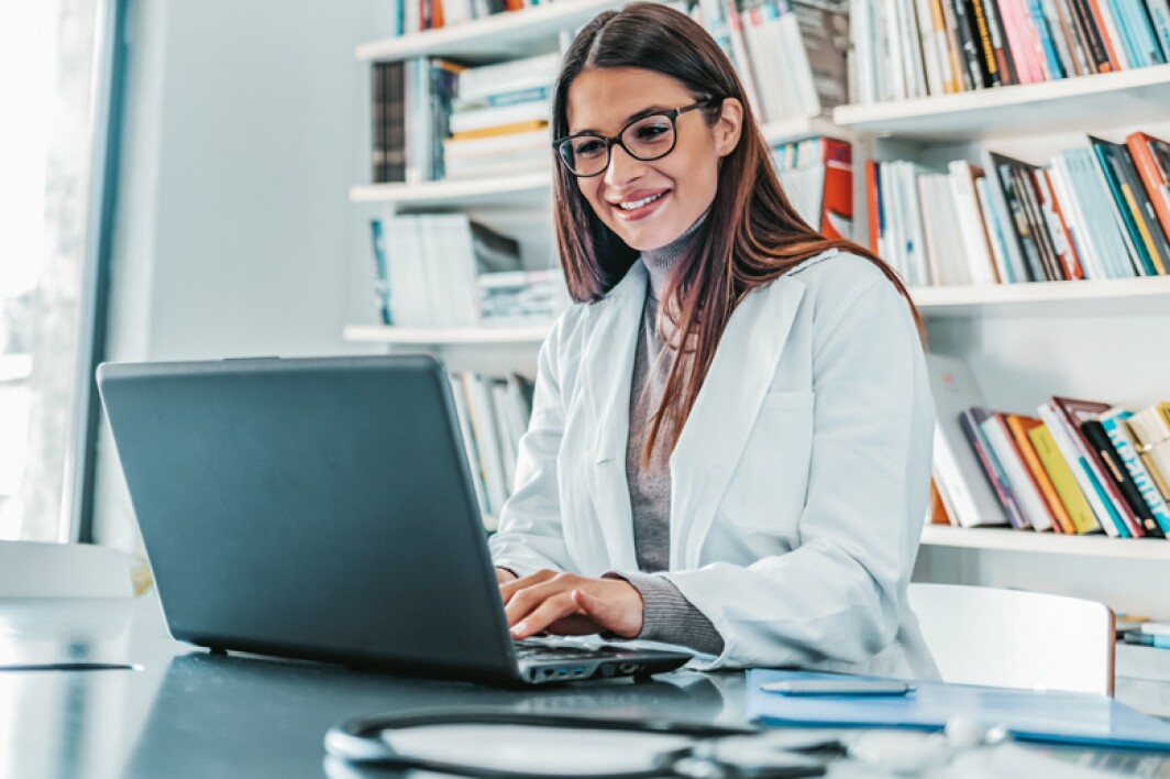 doctor working on a laptop in her office