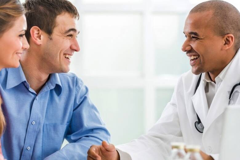 doctor speaking with a young couple
