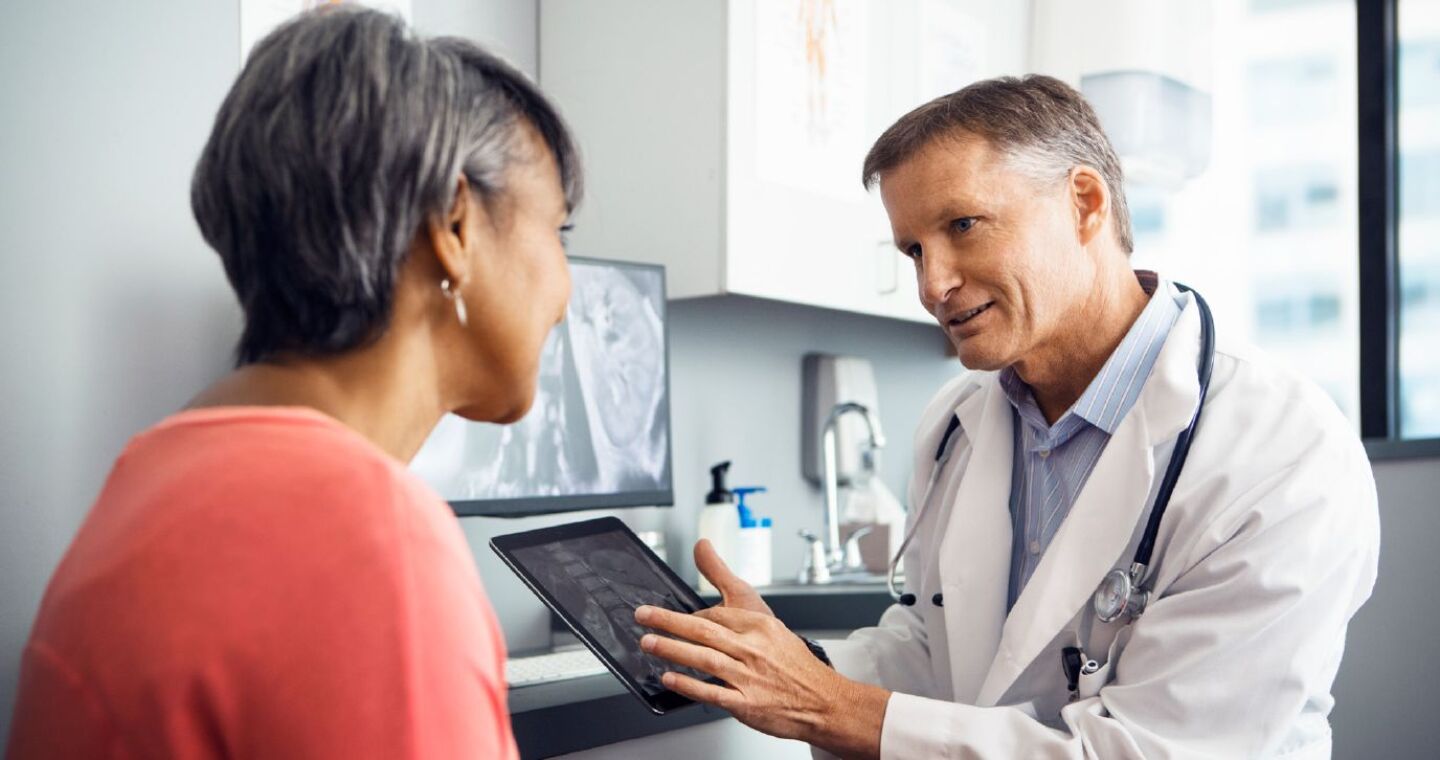 doctor showing patient imaging results on a tablet