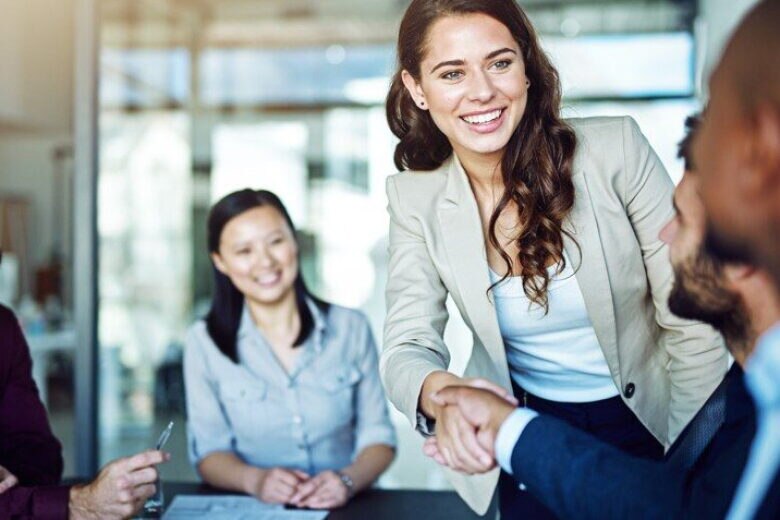 Woman shaking hands with a man's arm.