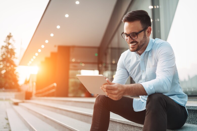 Business man looking at at tablet computer