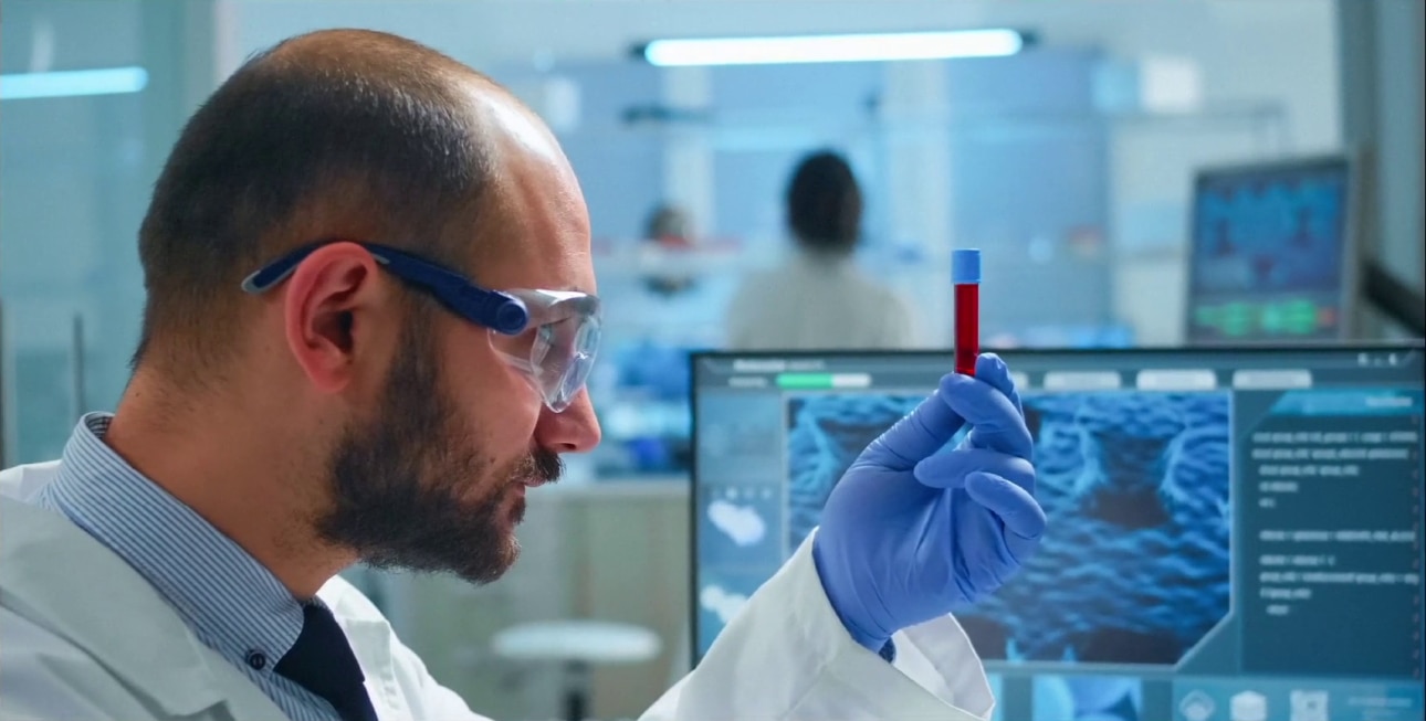 lab tech looking at vial