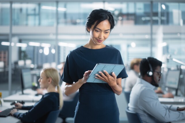 Woman looking at tablet in business office