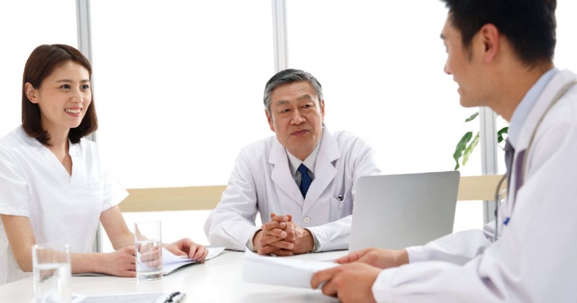 doctors having friendly discussion around a table