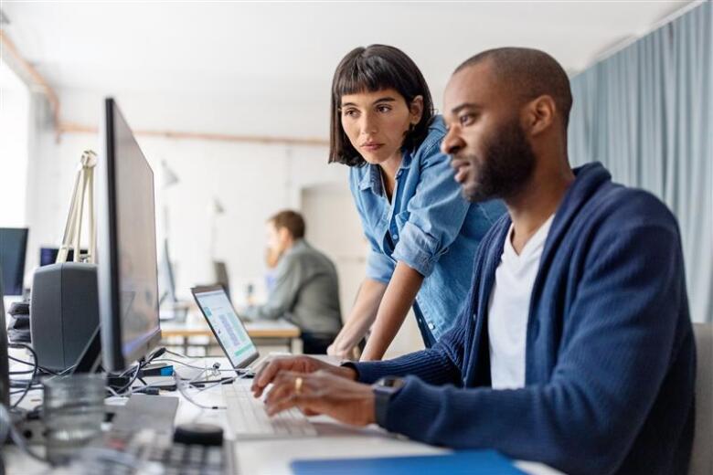 Two people working in the computer
