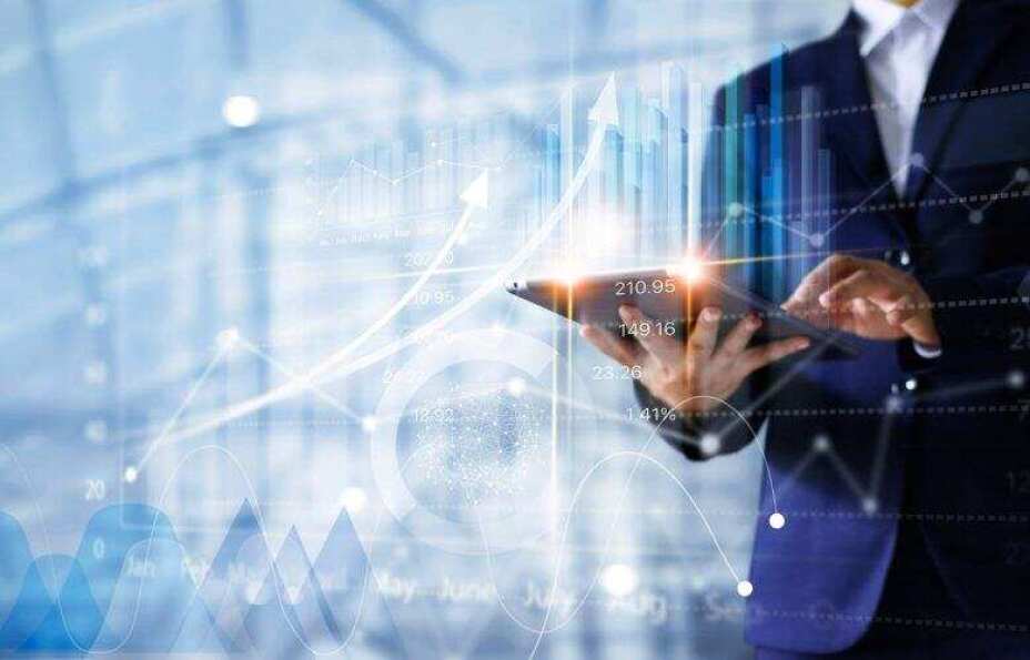 business man using tablet with transparent layers of data graphs