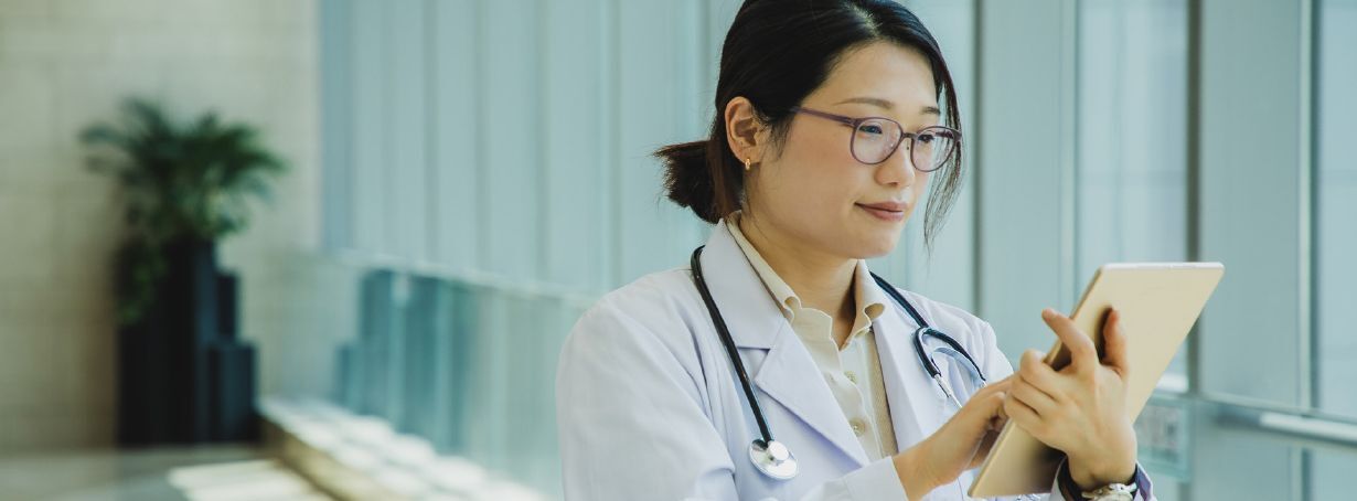 female doctor looking at ipad