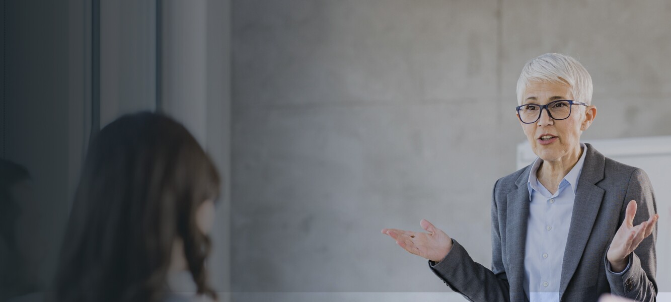 Senior leader giving a presentation to her team in the office