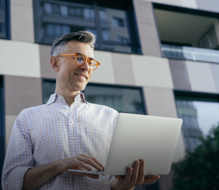 smiling mature man using laptop computer
