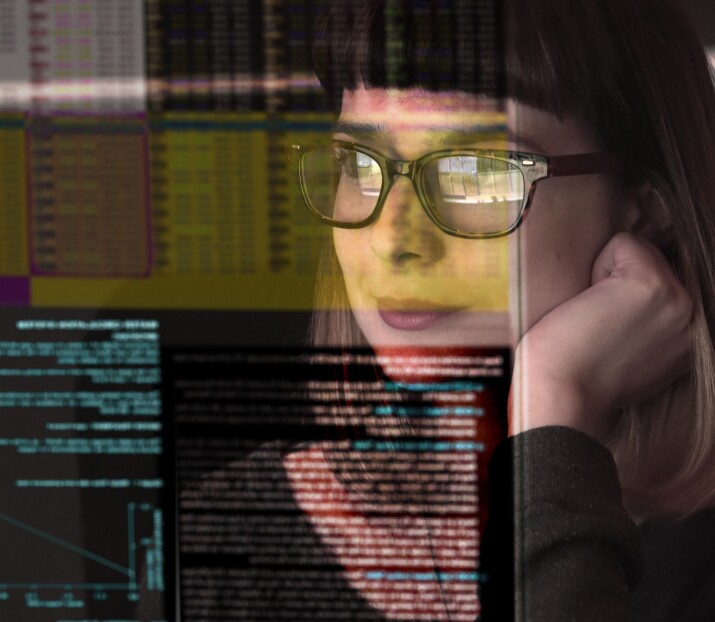 woman concentrating on a see through screen carrying a variety of data