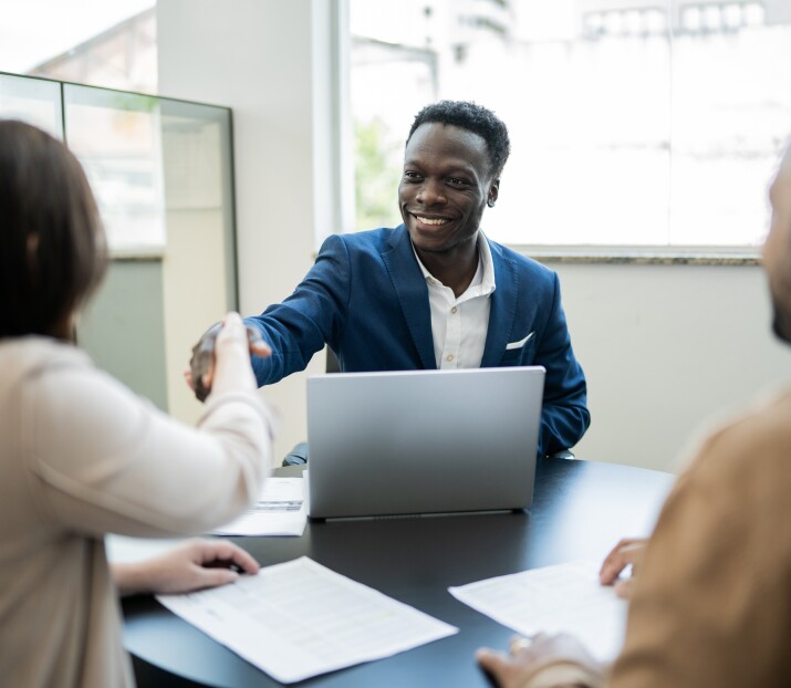 Customer shaking hands with salesman, financial customer