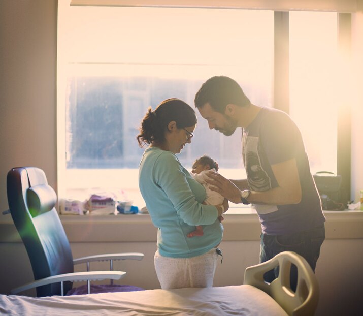 couple caring for their newborn baby in the hospital