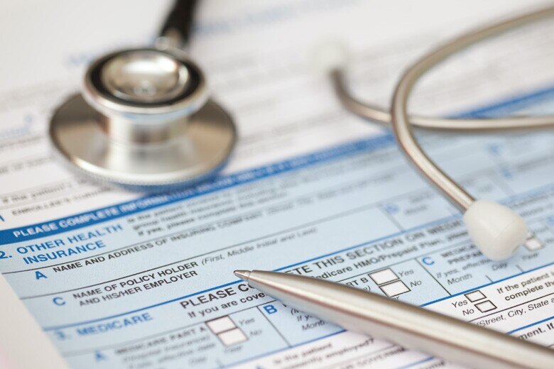 stethoscope and pen lying on a medical form