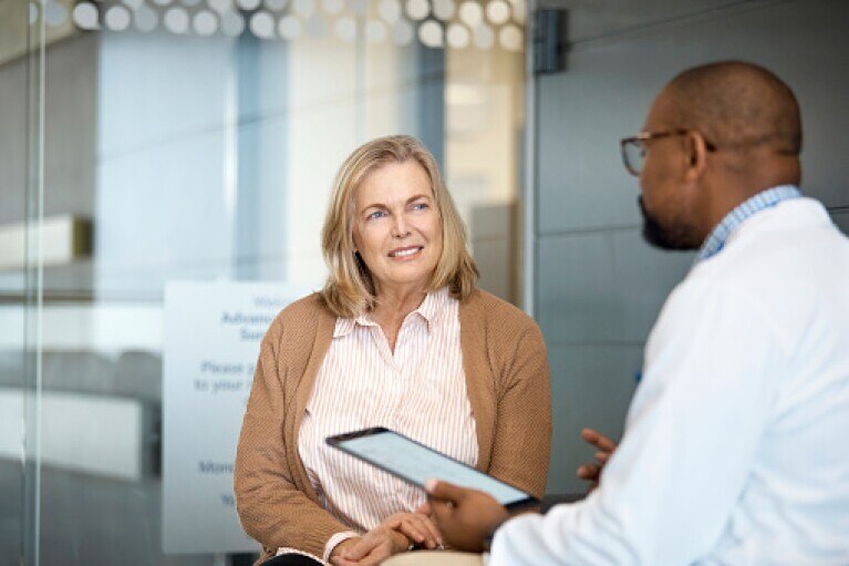Senior woman listening to male doctor.