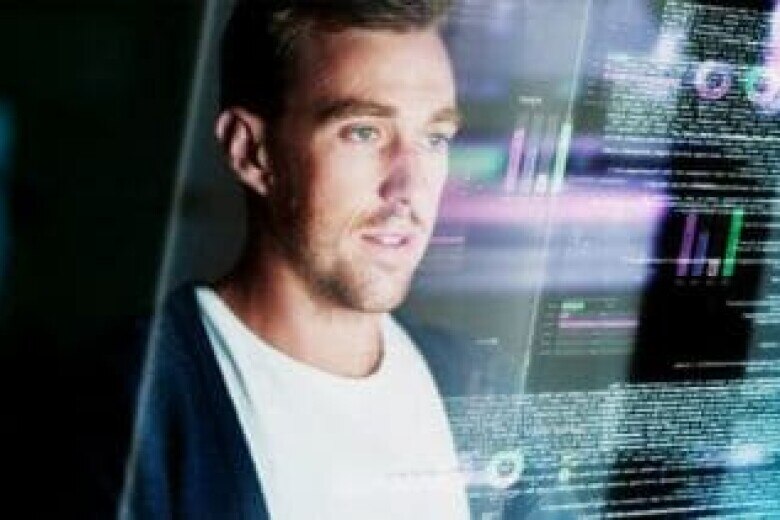 reflection of programmer in his computer screen