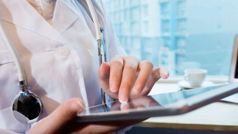 female doctor scrolling on a tablet