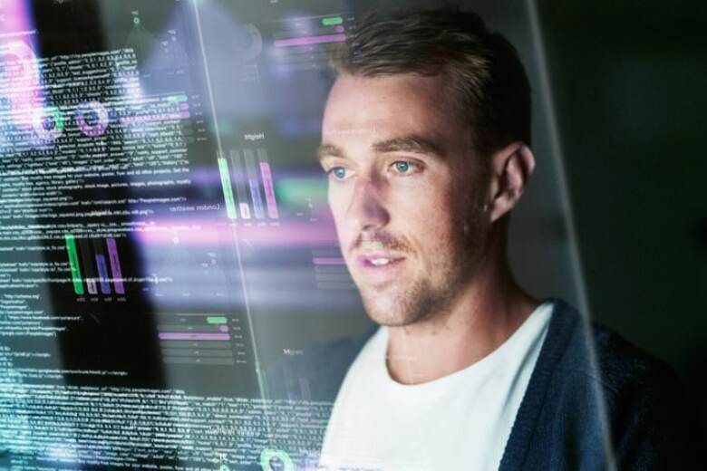 reflection of an app developer in his computer screen