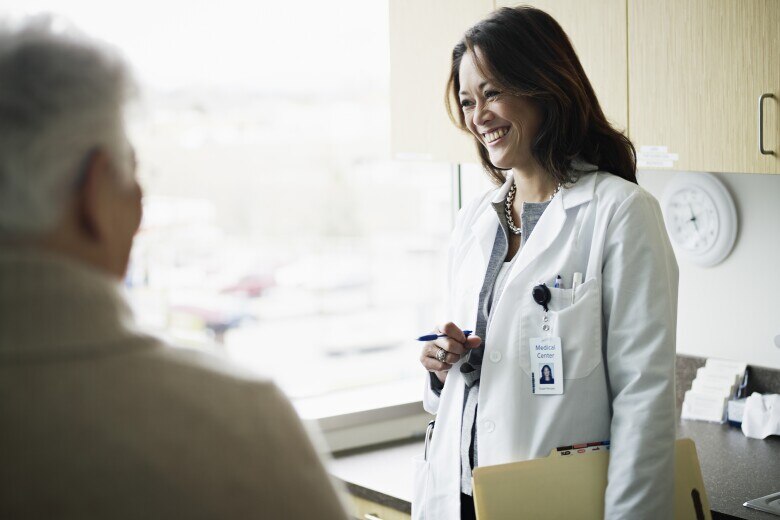 Doctor in discussion with mature female patient